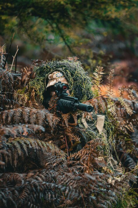 image of a military sniper in the bush somewhere