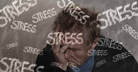 Man with hand in front of his face, stressed, with the word stress across the image