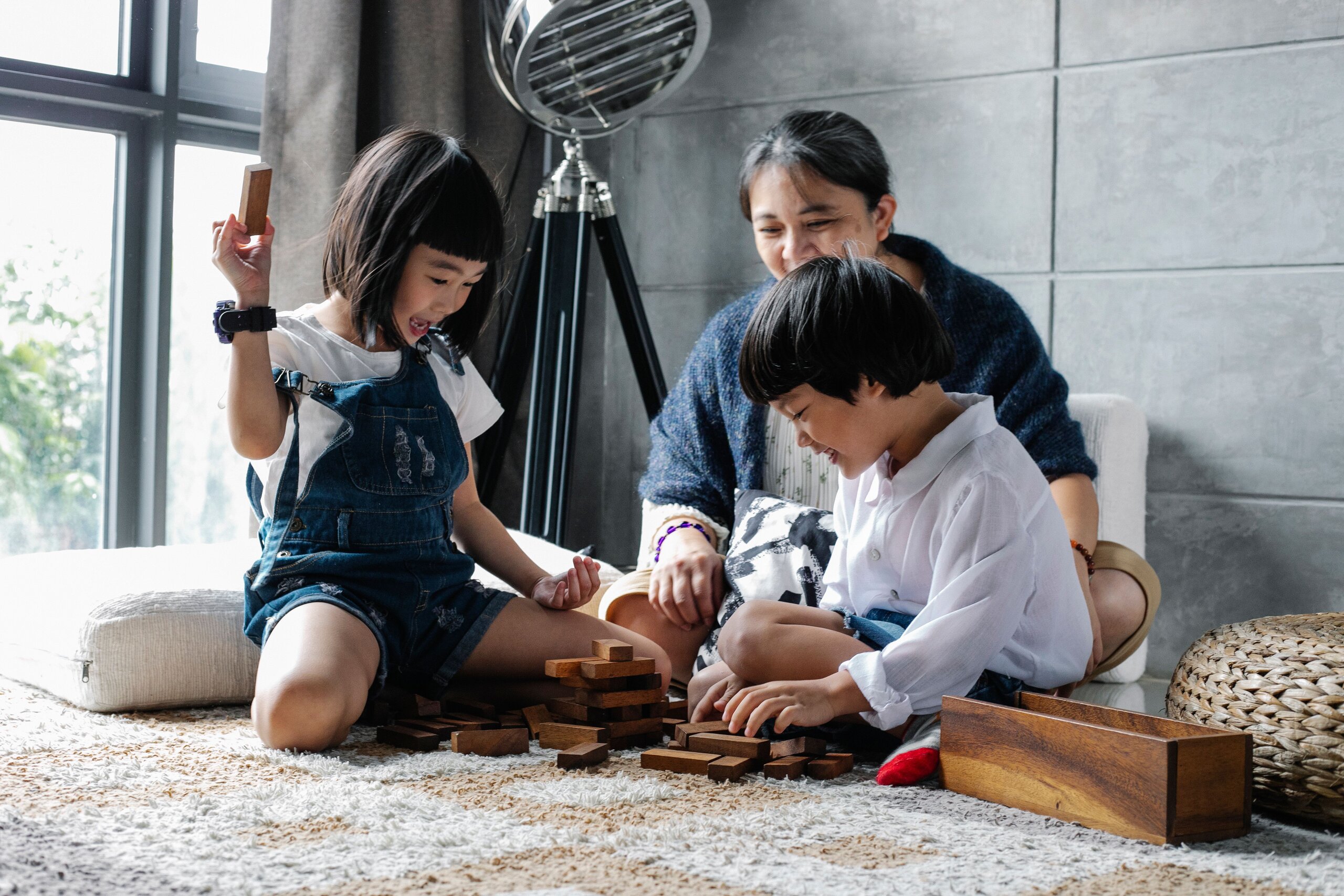 Asian children playing Image of two Asian siblings playing with their grandmother