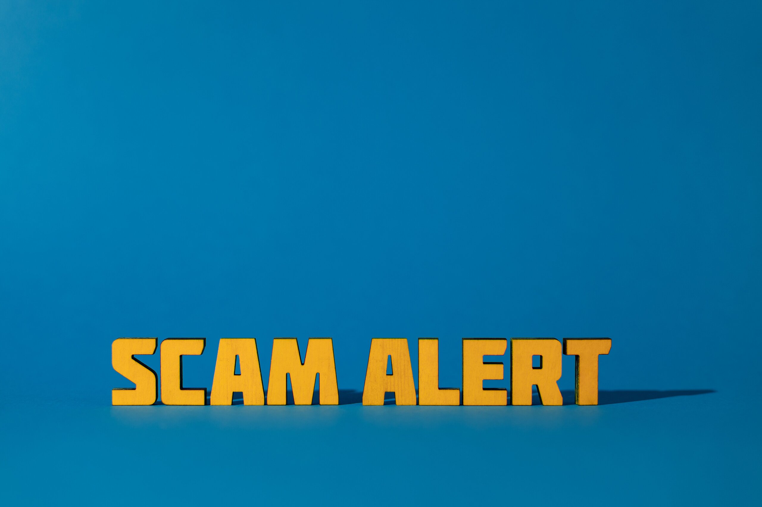 Scam Alert Sign Blue sign with Scam Alert in gold letters