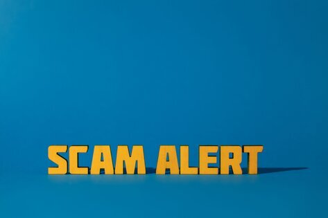 Blue sign with Scam Alert in gold letters