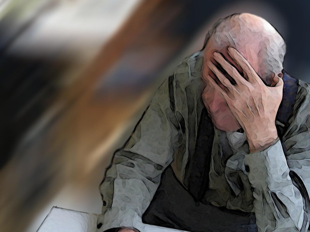 Depressed senior man with hand over his face