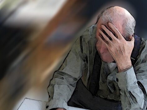 Depressed senior man with hand over his face